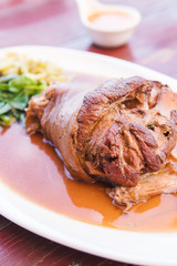 Stewed pork knuckle shot close up and pork leg were cooked with herbs and soy sauce.