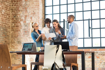 Young professionals working together in start up company, developing a business plan