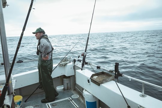 Fisherman standing in boat