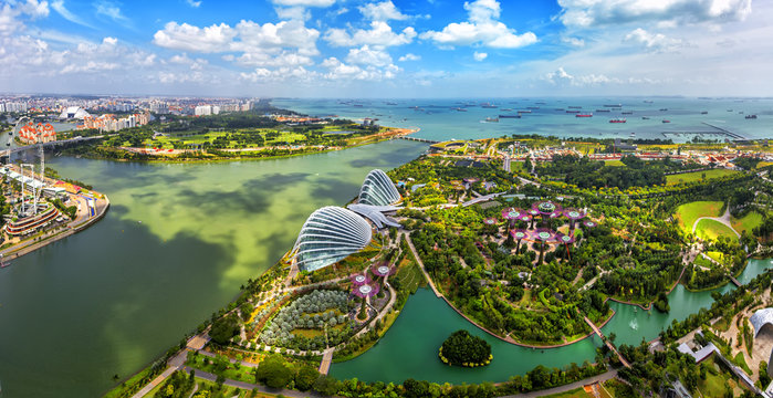 Panorama view of Singapore City skyline in Singapore. Bird eyes view of The Supertree Grove, Cloud Forest & Flower Dome at Gardens by the Bay on August 29,2016 in Singapore. Spanning 101 hectares.