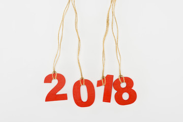 Obraz na płótnie Canvas close up view of 2018 year sign hanging on strings isolated on white