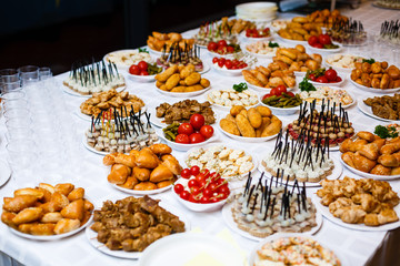Buffet table of reception with burgers, cold snacks, meat and salads
