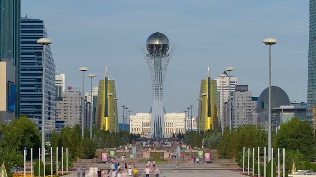 The city of Astana timelapse, residents are walking and relaxing on a sunny day near the symbol of the city - Baiterek area. Astana, Kazakhstan