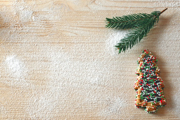Greeting card with Christmas tree cookie on wood