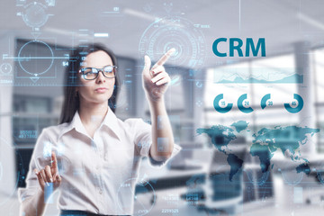 The concept of business, technology, the Internet and the network. A young entrepreneur working on a virtual screen of the future and sees the inscription: CRM