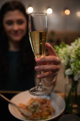 Woman having champagne while dining