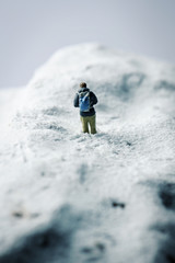 Fototapeta na wymiar miniature hikker in a snowy landscape