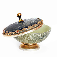 Open casket. Round old casket on a white background. Casket for candy. Old dishes.