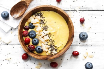 Overhead view of Breakfast mango smoothie bowl / Healthy eating concept
