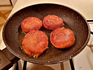 Juicy appetizing cutlets from carrots are fried in oil in a frying pan
