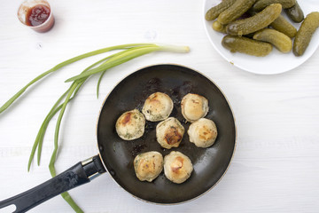 Fried dumplings in a frying pan.