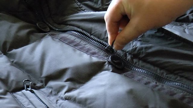 Video shows zipper closure on the blue jacket