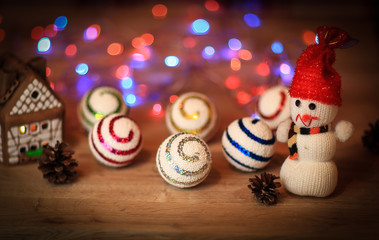 Christmas balls and a toy snowman on Christmas table