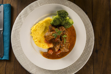 Delicious healthy food with cooked meat, mashed potatoes and vegetables on the plate. View from the top.