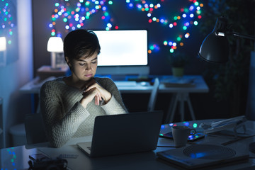 Woman connecting with her laptop at night