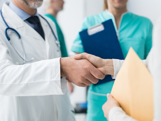 Doctor and patient giving an handshake