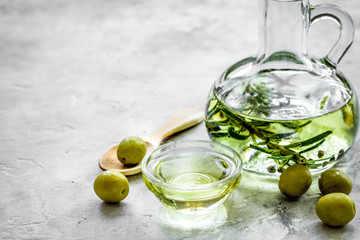 oil in carafe with spices and olive on stone background mock-up