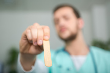 doctor checking child sore throat