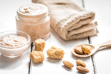 natural scrub with almonds and towel on light table background
