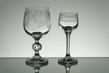 Crystal glass illuminated on mirror and black background