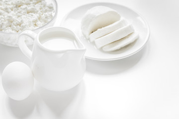 Fototapeta na wymiar Healthy food concept with milk and cottage cheese on white table