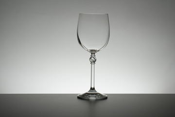 Crystal glass illuminated on mirror and black background