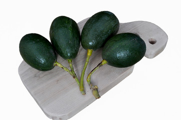 avocados on cutting board with white background