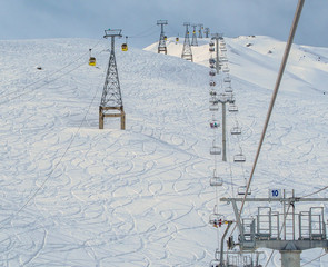 Gondola cabins, Ski Lift and mountain ski slopes during the winter season. © Gagula