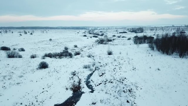 Small frozen river. Ice and snow. Aerial view landscape