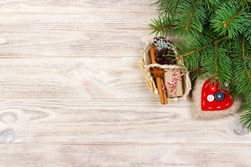 Festive Gift boxe with heart, star anice, basket, cinnamon and snowflake on Wooden Background. Christmas Presents with copy space