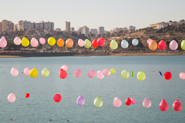 Colorful balloons are looking at city