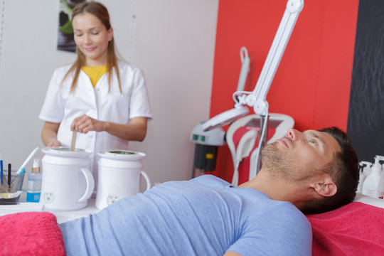 therapist ready to give laser epilation treatment to man