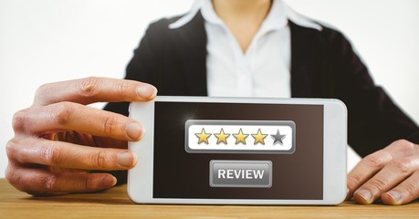 Woman holding phone with review button and star ratings