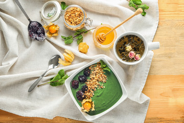 Composition with yummy spirulina smoothie on wooden table. Healthy vegan food concept