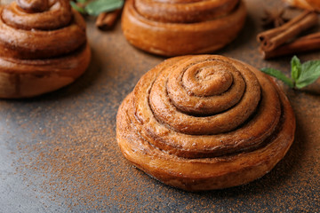 Sweet cinnamon roll on table
