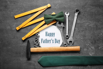 Set of tools with greeting card on dark background. Father's Day concept
