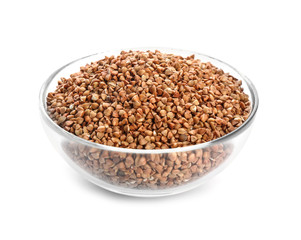 Bowl with raw buckwheat on white background