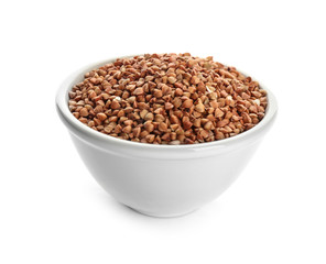 Bowl with raw buckwheat on white background