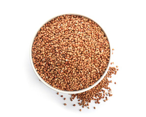 Bowl with raw buckwheat on white background