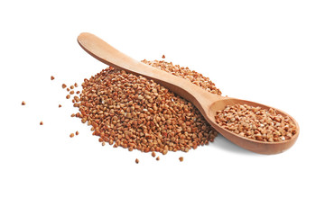 Raw buckwheat and wooden spoon on white background