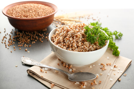 Bowl with cooked buckwheat on table