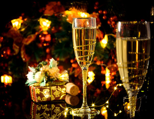 Two glasses of champagne over blur spots lights background. Celebration concept, free space for text