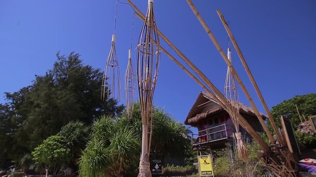 Penjor is swaying in the wind on the blue sky background. Penjor is the decorative bamboo pole. Thailand.
