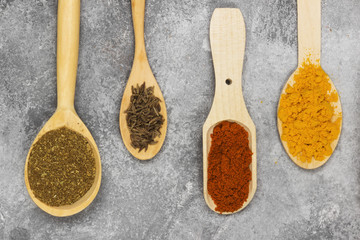 Various spices on a gray background. Top view. Food background