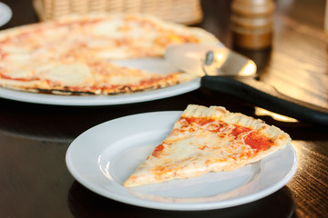 Pizza four cheese on white ceramic plate.