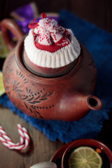 Christmas teapot with the red santa hat on it.