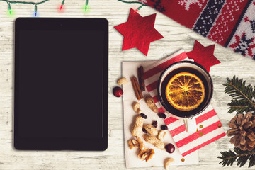 Tablet on a wooden table, christmas scene