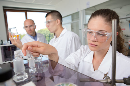 shot of three focused scientists working in their chemistry lab
