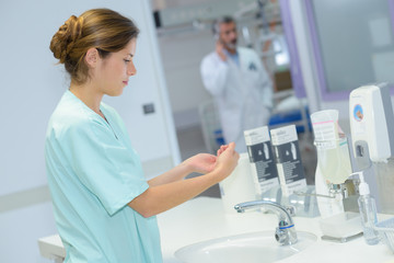 young beautiful nurse washes hands