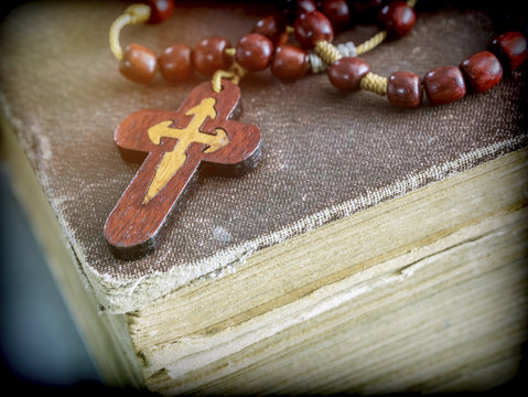 An ancient rosary on an old book